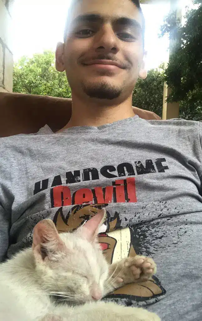 An man awakens from a nap with a stray kitten sleeping on his stomach and decides to keep it 2