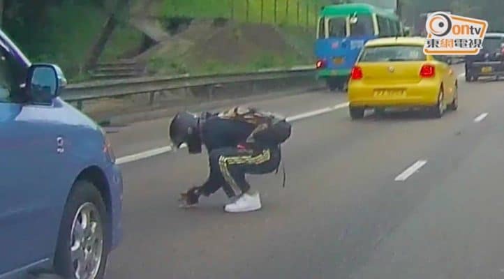 On a busy highway a man stops traffic to save a tiny kitten 2