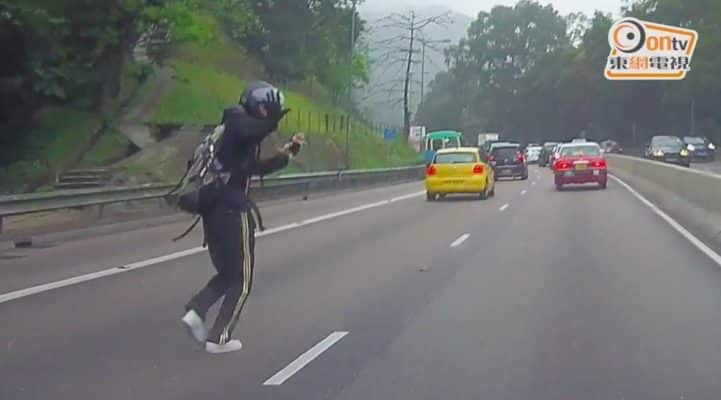 On a busy highway a man stops traffic to save a tiny kitten 3