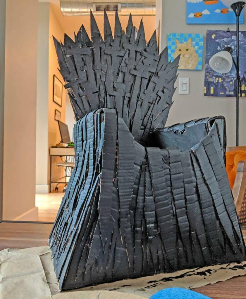 The cat's owner built an iron throne for her cat out of cardboard much like in Game of Thrones 4